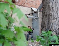 Sexy blondie empties her bladder behind a building