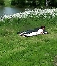 Nude sunbather takes a leak on a huge open field