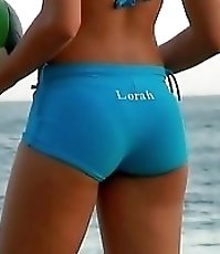The perfectly shaped amateur gal is playing with the ball in sport shorts on the beach
