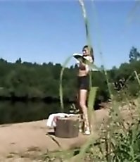 Exciting shaved teen peeing near the lake