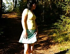 Cute brunette squats down to take a leak in forest