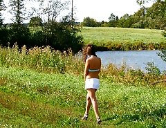 She takes a leak while walking through countryside